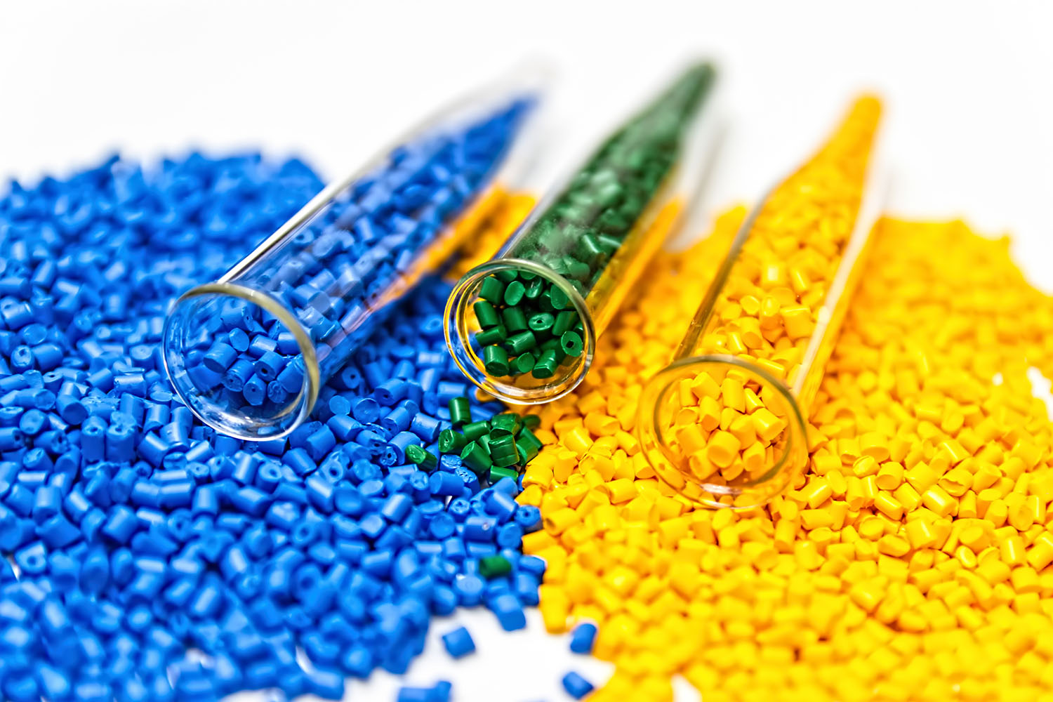 Not mixed together blue, green and yellow PVC granules