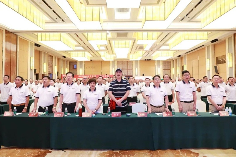 Xingyi Decoration company members standing up in the glorious ballroom.
