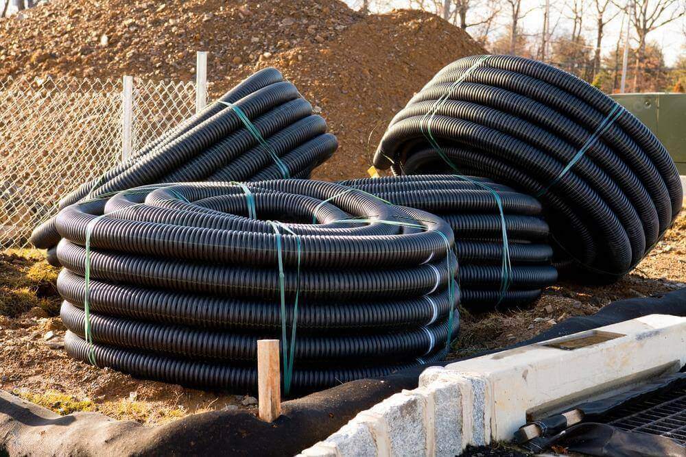 HDPE conduits buried along a roadside, featuring high crush resistance for underground traffic-heavy areas